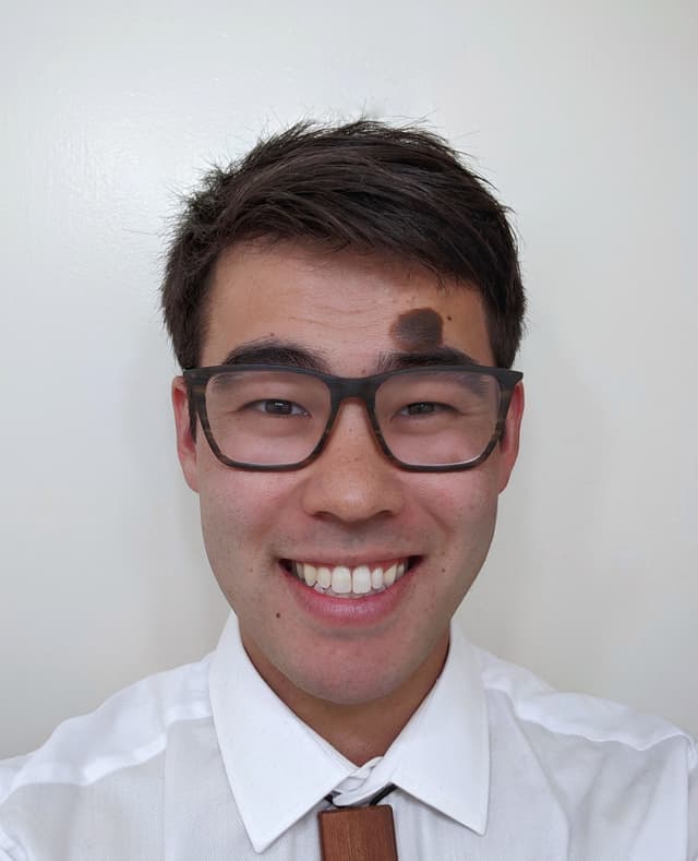 A professional headshot of Timothy Akana